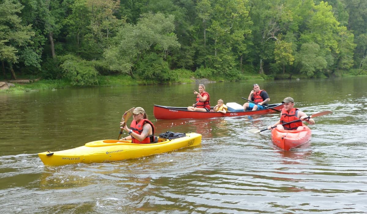 Group of paddlers in canoes and kayaks doing 10 Mile Challenge trip with Cape Fear River Adventures.