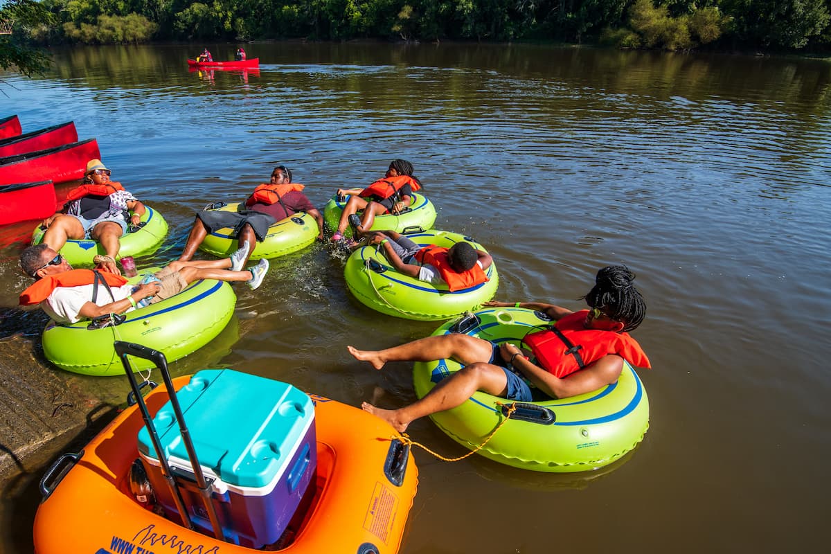 Group of friends river tubing on the Cape Fear River in Lillington, NC