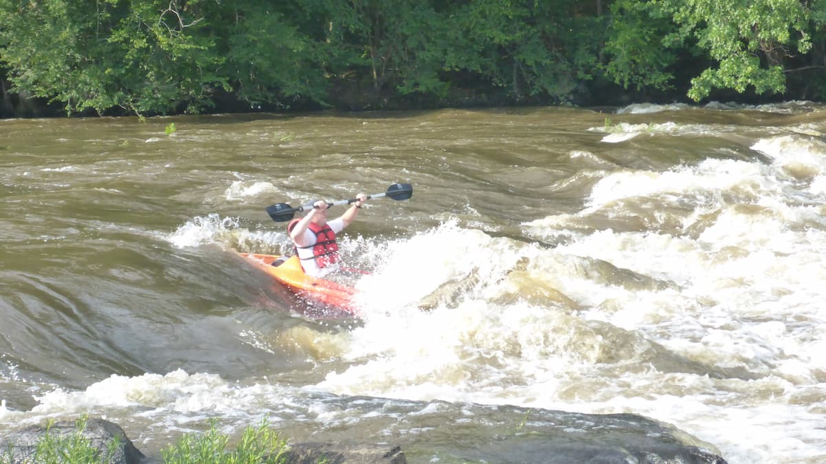 Kayaker going through a rapid on Cape Fear River