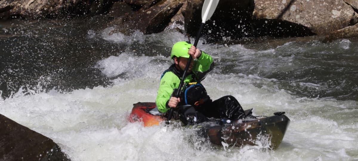 Whitewater kayaker with Cape Fear River Adventures in Class III rapids near Lillington, NC