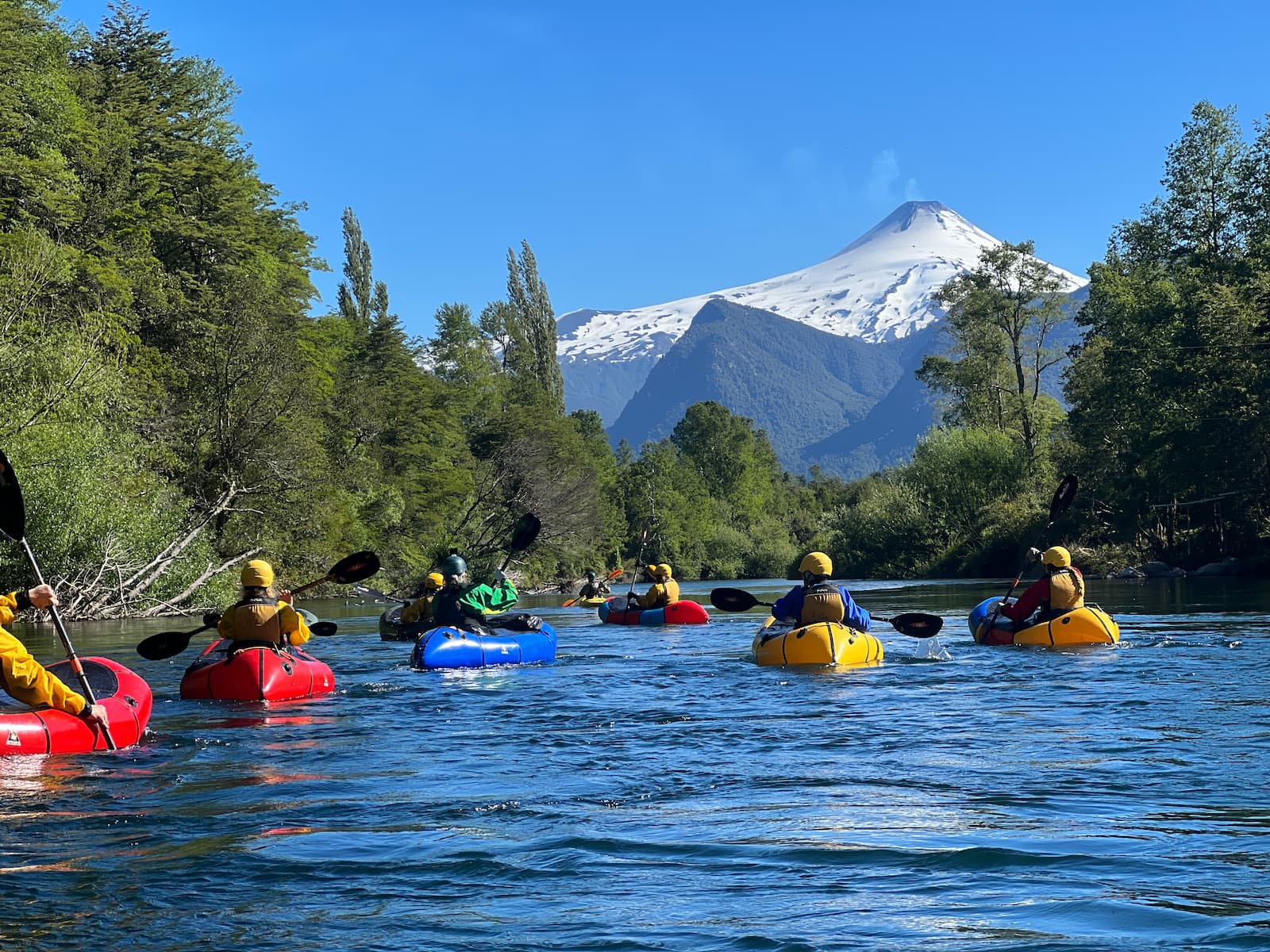 whitewater kayakers with volcano view in Pucon Chile