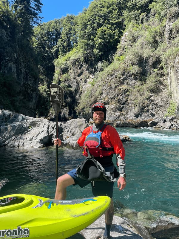 Kayaker below waters falls on the Upper Fay River near Pucón, Chile