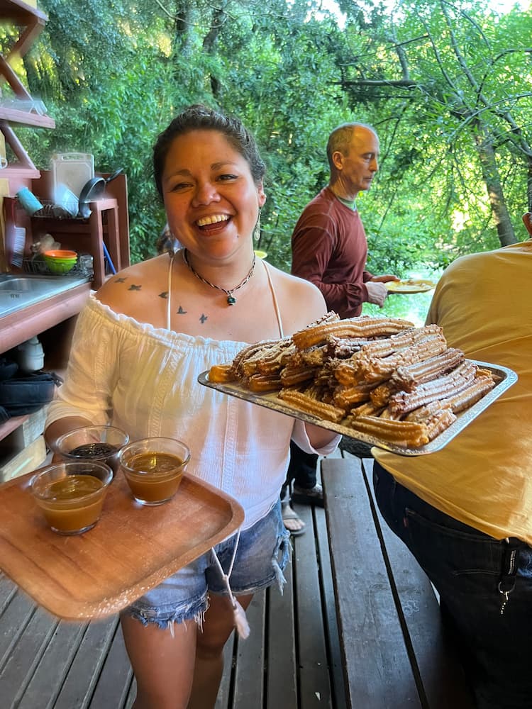 Chilian lady is serving food at Pucón Kayak Retreat