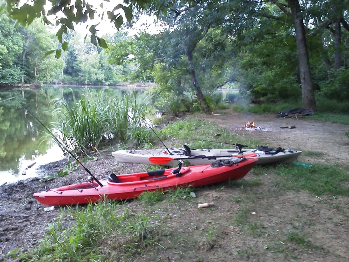 Kayaks on the river banks with bonfire near Lillington, NC